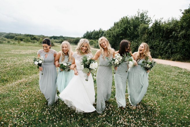 Bride and bridesmaids walking and laughing | Kelly Chandler Consulting