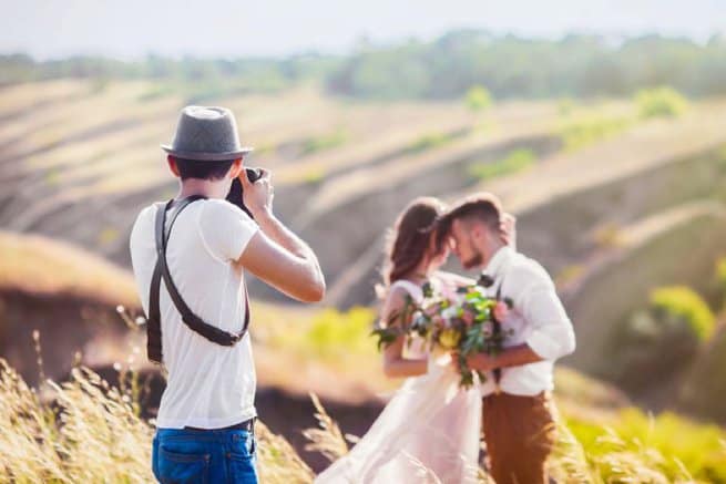 Wedding photographer with bride and groom | Kelly Chandler Consulting