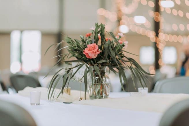 Vase coral flower and leaves in table centrepiece | Kelly Chandler Consulting
