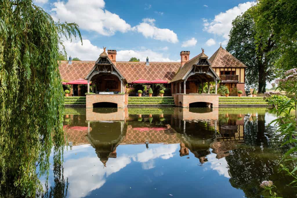 The Dairy at Waddesdon Manor wedding venue reflected in the ornamental moat — wedding venue success