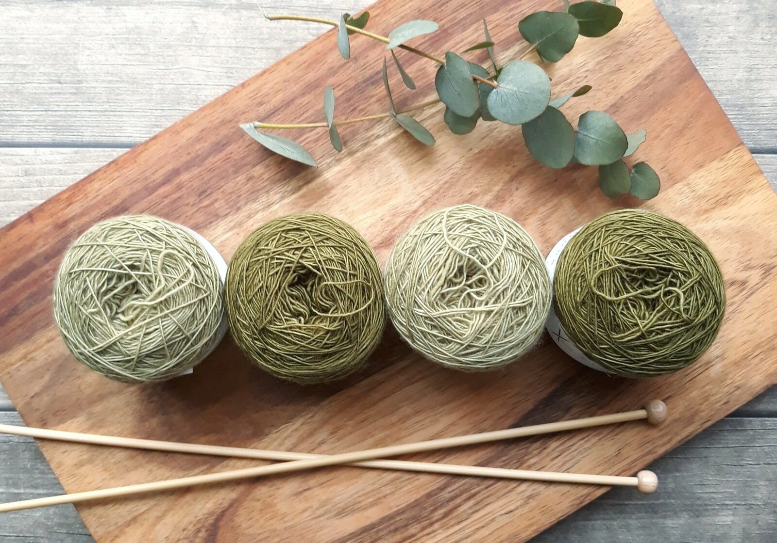 Four green balls of wool